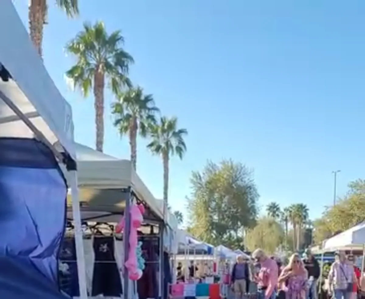 A sunny outdoor market in Yuma with rows of local vendor tents
