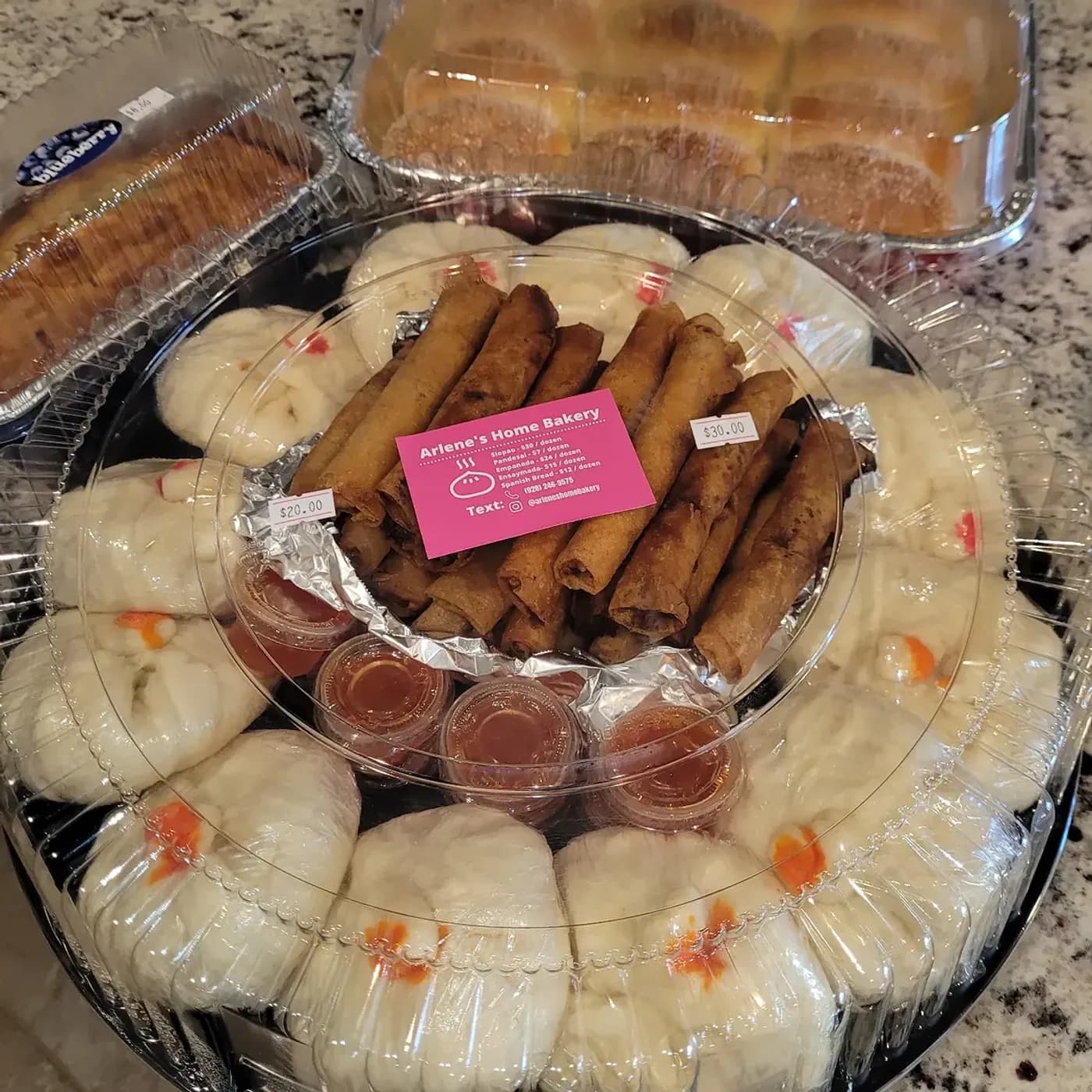 A party platter of lumpia and siopao prepared by Arlene's Home Bakery